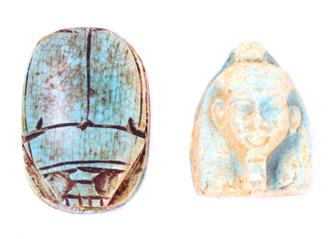 Group Lot of Faience Scarab & Mummy Mask Beads: Two artfully crafted Egyptian faience beads including one scarab with intricate detail throughout including a classic seal to the base, drilled through the center for suspension. Includes a wonderfull