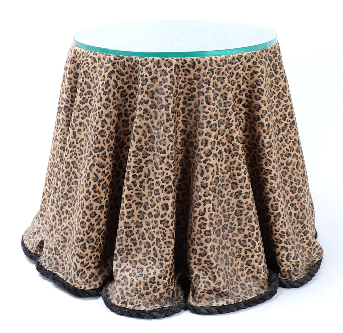 Original Trompe L'oeil Leopard Print Table: Lovely hand crafted Trompe L'oeil draped leopard drinks table, with fitted circular glass top. Comprised of fiberglass that is draped over a round wood top and fans out with graceful folds to the floo