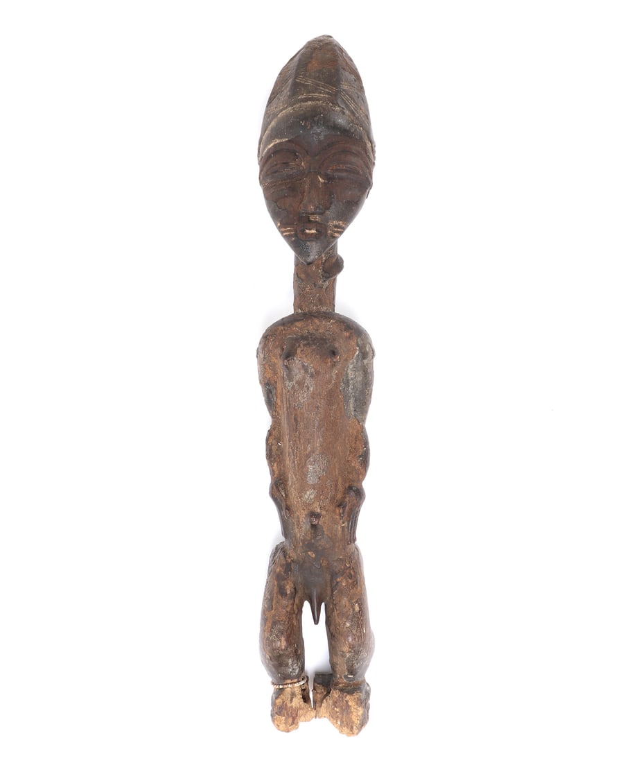 Nicely Carved Senufo Standing Figure: Handsome hand carved wood standing figure, depicting a male in the nude with his arms at his waste. Beaded anklets on his right foot. Incised almond slit eyes with incised scaring to the face, and ela