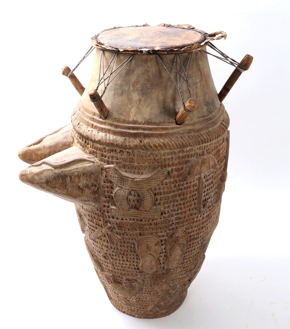 Large Early Wood Carved African Ntan Drum: Akan Peoples, Africa. Heavy wood carved African ntan or mother drum representing the chief, queen mother and members of the court. These drums are always depicted with large protruding breasts to indi