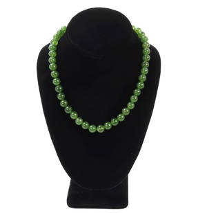 Beautiful Light Green Jade Style Beaded Necklace: Lovely Chinse jade style beaded necklace with dozens of various shade of green beads throughout. Size 16 1/2" L, bead 3/8" W