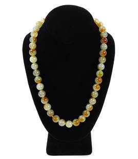 Lovely Mottled Green Jadeite Style Beaded Necklace: Gorgeous light green and brown mottled jade style beaded necklace. Dozens of beads throughout each with unique beautiful wave patterns. Size 21" L, bead 1/2" W