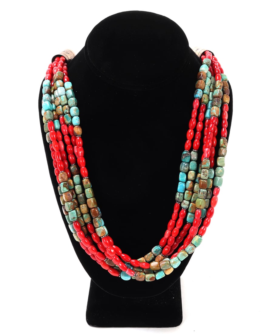 Six Stranded Coral & Turquoise Necklace: Gorgeous bright red and turquoise necklace, wonderfully made into four strands with interchanging sections of coral and turquoise. Hammered tube beads at the clasp. Size 24" L, bead 1/4" L
