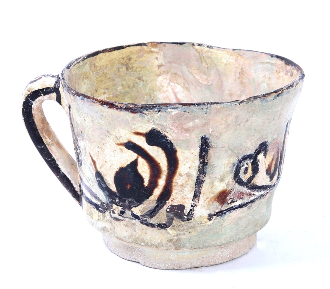 Fine Kufic Script Islamic Tea Cup: Beautiful early Islamic earthenware cup with Kufic script painted to the exterior in a cocoa brown pigment. D shaped handle with brown painted accents to the exterior and rim. Size 4" W, weight 231 g