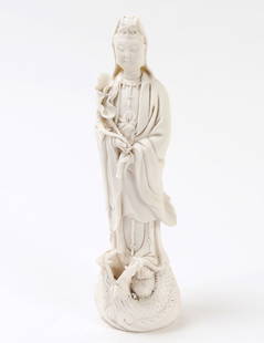 Chinese Blanc de Chine Guanyin: Chinese porcelain standing Guanyin in a beautiful matte white. She is depicted standing in long flowing robes with a dragon wrapped around the base as she stands on a flaming pearl. Holding a willow b