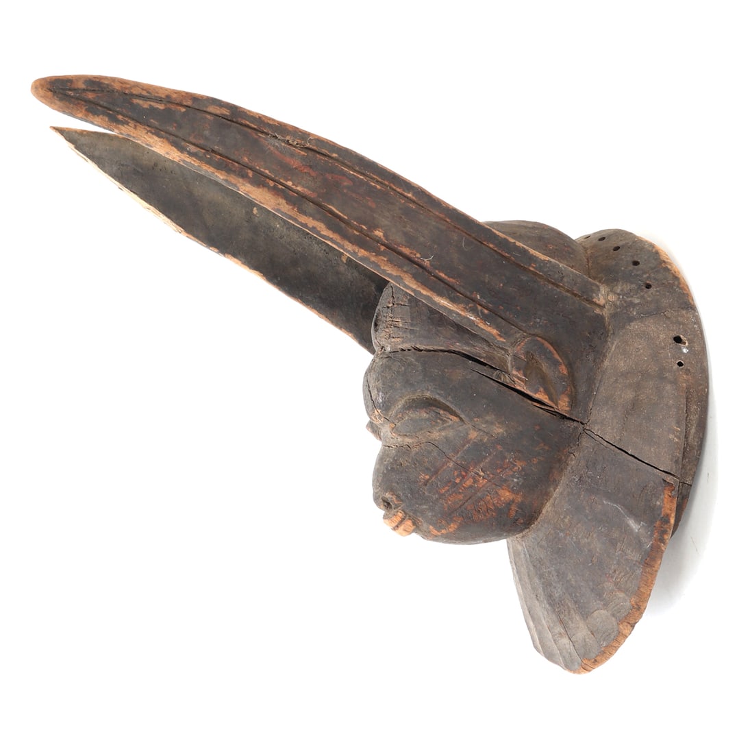 Wood Carved Yoruba Egungun Mask: Handsome wood carved Yoruba Egungun helmet style mask. Skillfully carved from a single piece of wood, the mask features intricate facial details and tall, elegant ears, symbolizing the connection to a