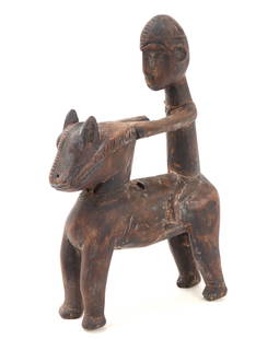 African Wood Carved Dogon Horse & Rider: Carved from a single piece of wood featuring a detailed figure of a rider upon a stylized horse. Incised details to the horses head and horse bit. The rider wears an elaborate helmet with almond shape