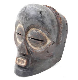 Mbagani Mask, Democratic Republic of Congo: Handsome wood carved Kete mask from the Mbagani tribe. Typically used during healing rituals, carved from a single piece of dark wood. Added white pigment highlights the eyes and mouth of the mask wit