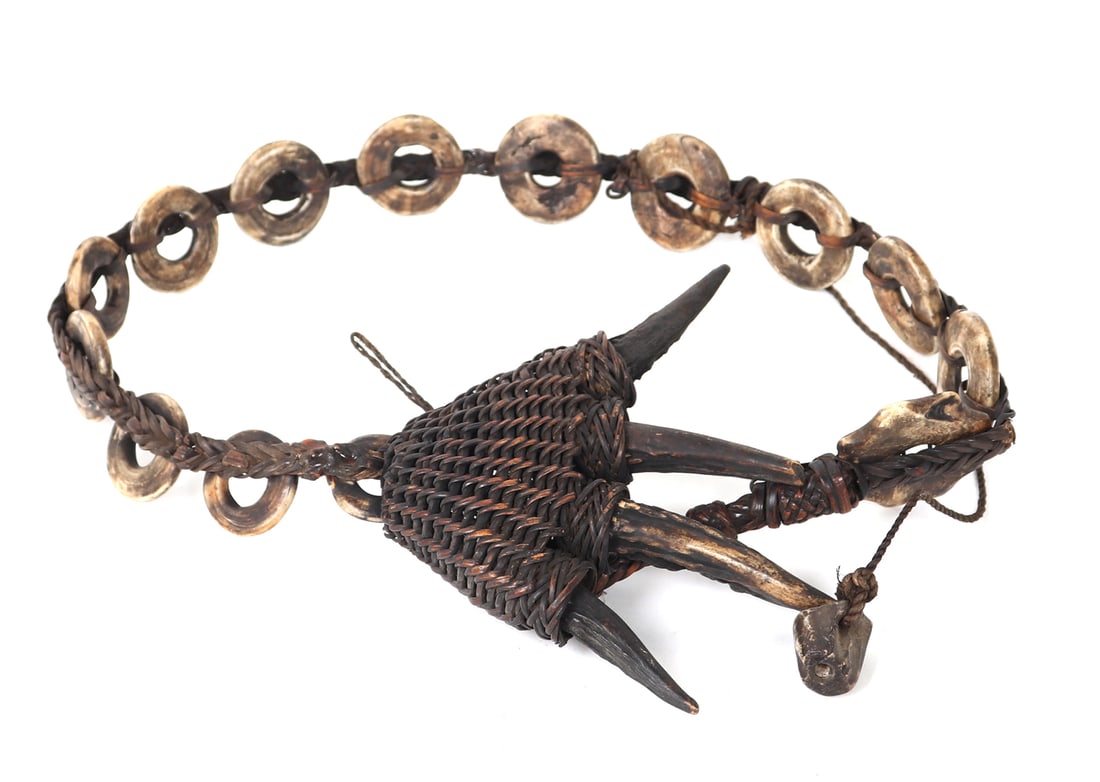 Bone & Antler Philippines Rattan Belt: Woven with rattan, antlers act as claws with circular bone carved additions, this is most similar to a head hunters belt. Typically there would be a dagger with a sheath attached to the belt as well.