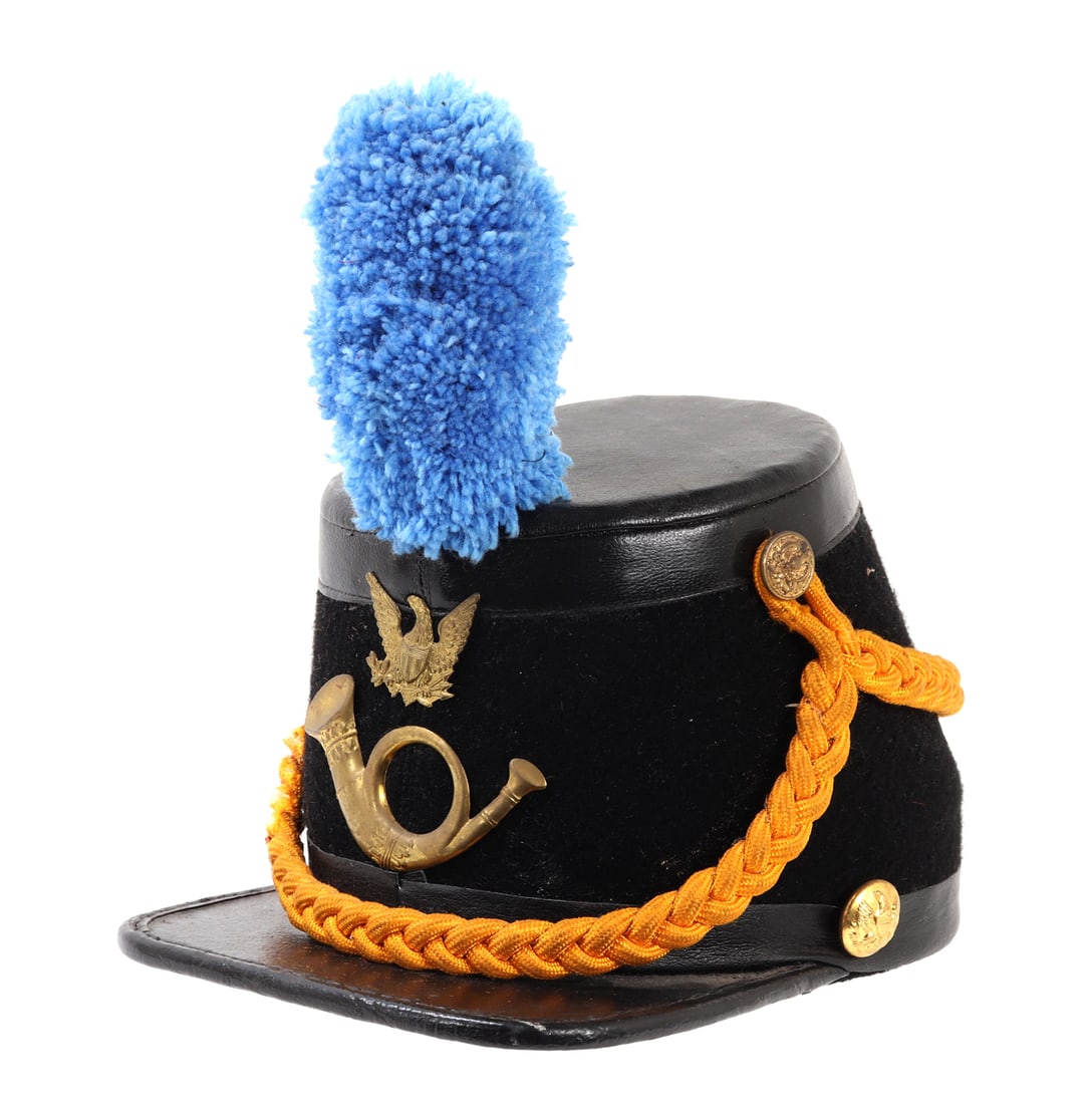 US Army Officer's Style Shako Hat: Probably modeled after the 1872 Infantry Officers Shako hat. Felt body with bright yellow intertwined cord. Bright blue plum. Plaques to the front of an American eagle and trumpet below. American eagl