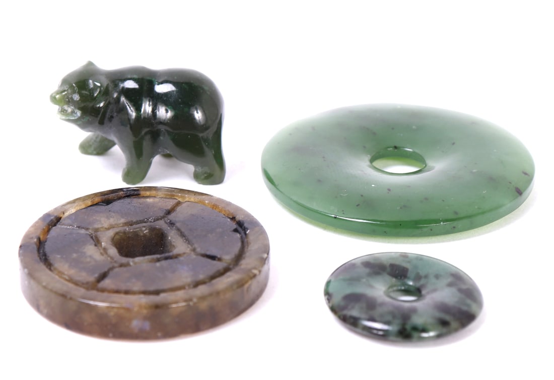 Group of Four Chinese Jade Pieces: Fine group of Chinese jade pieces including an adorable miniature jade bear figurine, two bi-disc pendants and a mottled white jade style currency pendant. Size biggest 1 5/8" L, 36 grams total
