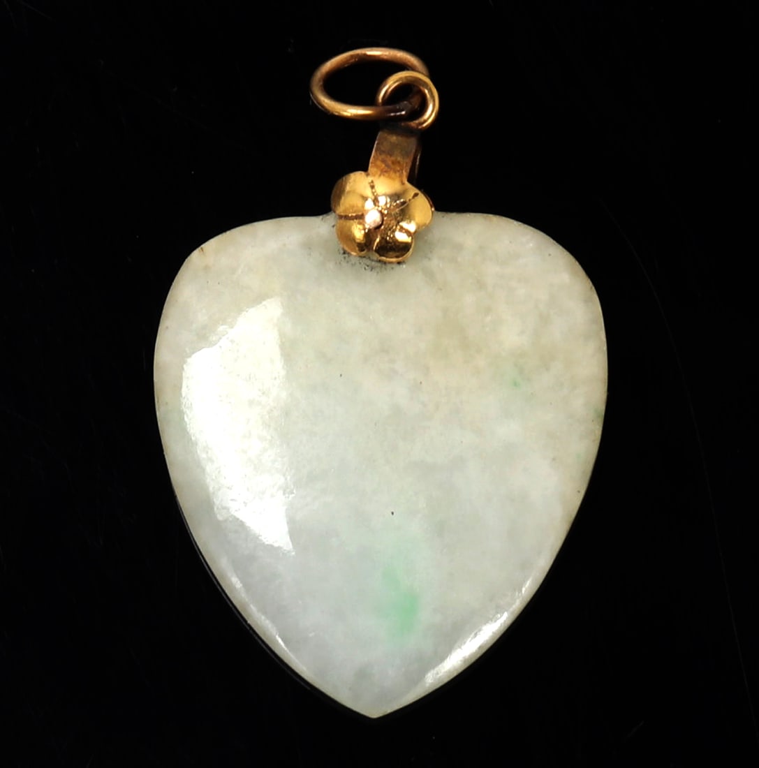 Chinese Heart Shaped Jade Pendant, 14k Gold: Lovely Chinese jade heart shaped pendant with a 14 carat gold clasp and loop with a flower. Lovely light green color with on striking bright dot of green to the center. Size 1 1/4" L, Weight 4 g