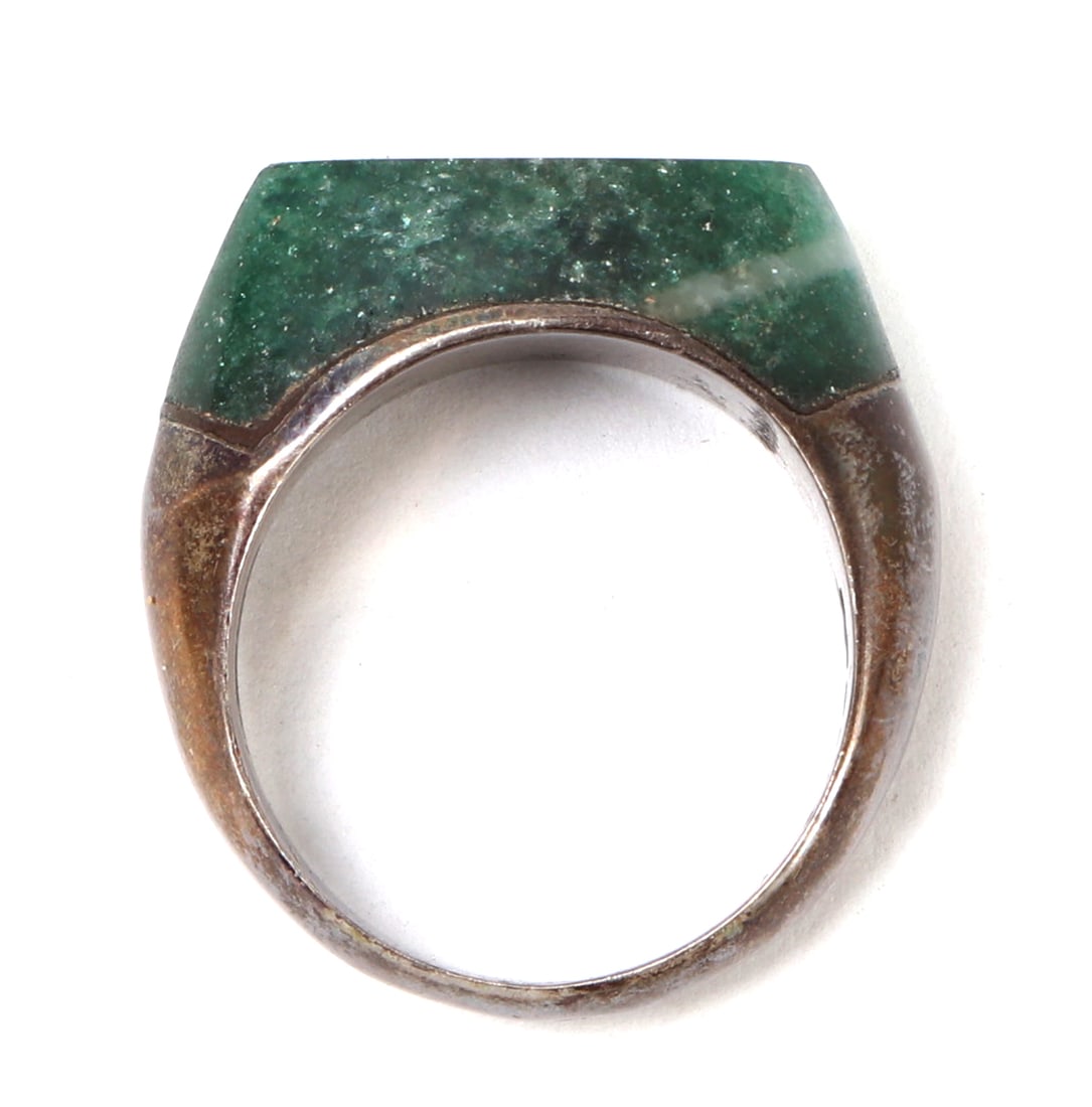 Lovely Chinese Jade Style Ring: Nice Chinese jade style ring with a sterling silver band. Green stone shaped into a rectangle with smoothed edges. Size 1" L, Inner 3/4" L x 5/8" W, stone 7/8" L x 3/8" W x 3/8" H, weight 11 grams