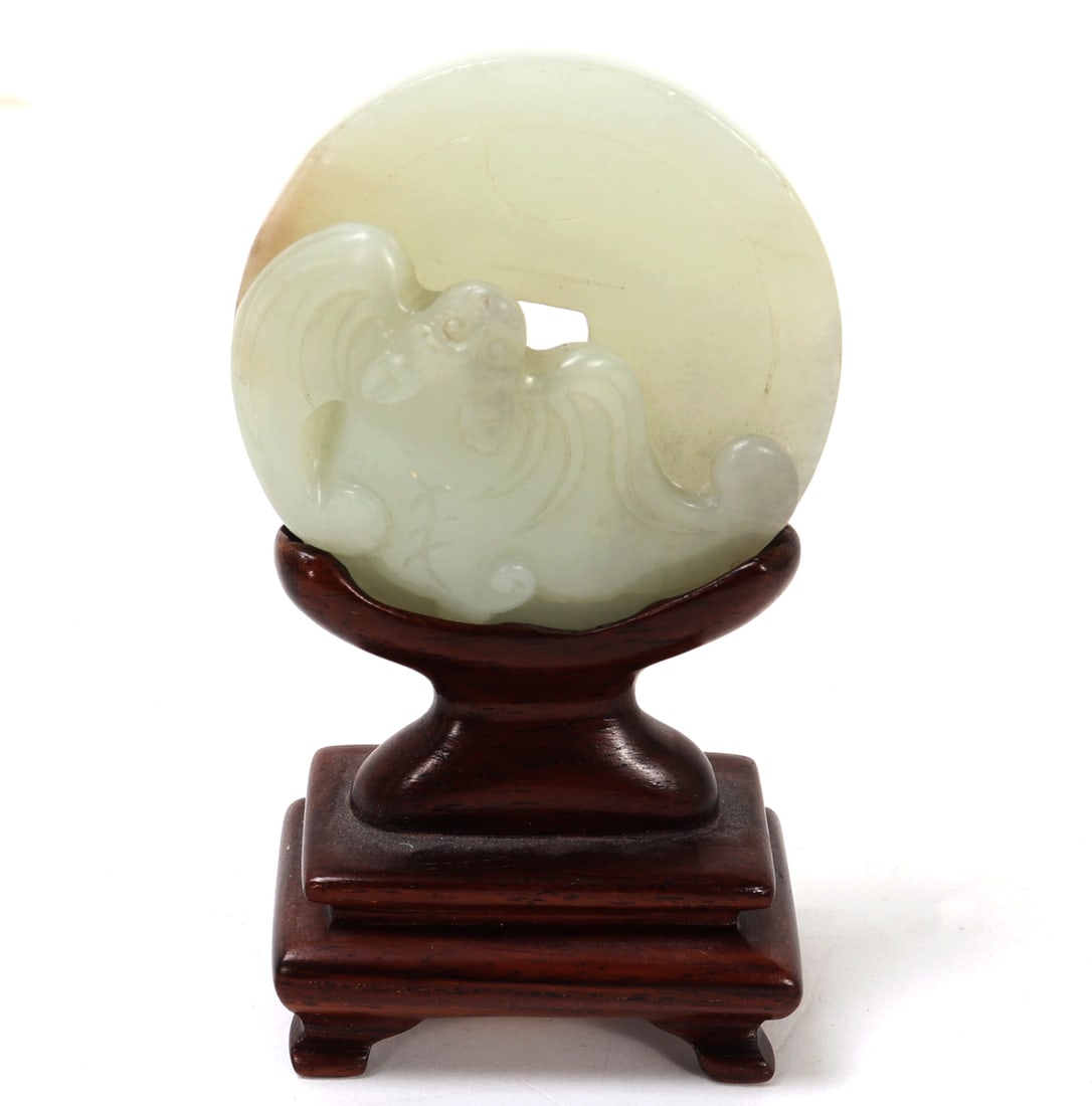 Chinese Jade Coin with Bat on Custom Stand: Beautiful Chinese jade carved coin with a bat in high relief to the top with incised details throughout. Custom wood stand for easy display. Size 3 7/8" H x 2 1/8" W