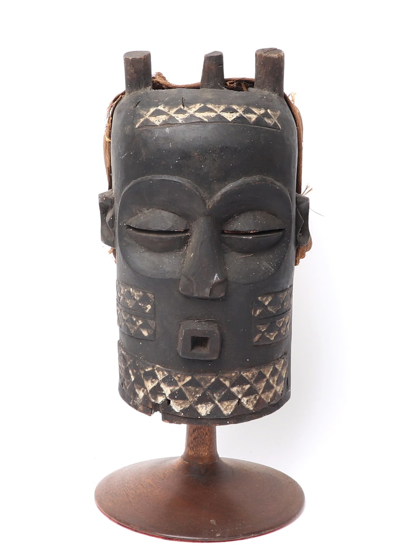 African Bene Buyonbo Mask: Handsomely carved wood mask with triangular bands with white throughout the top triangles. Almond shaped slit eyes with round eyes. The mask has horns and braided material in order to wear for ceremon