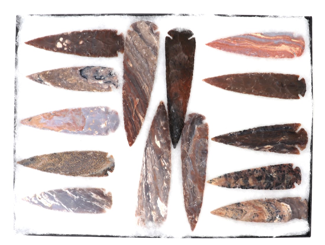 Wonderful Collection of 14 Native American Arrowheads & Spears: Nice well preserved collection of fourteen hand naped Native American arrowheads and spearheads in various stone compositions with one having almost crystal or quartz inclusions throughout. Size large