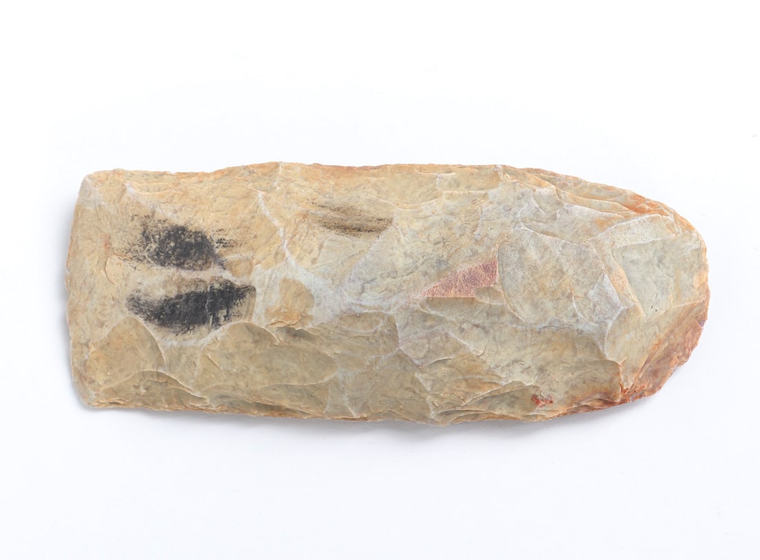 Neolithic Stone Axe Head: Fine Neolithic stone flint or axe head recovered from the African continent near Nigeria and probably 6,000-2,000 years old. Well knapped with a light cream color and red hues, the Manganese deposits