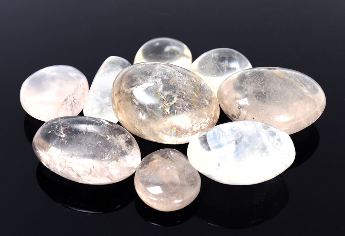 Fine Group of Nine White Quartz Palm Stones: Very nice collection of nine polished white quartz palm stones with beautiful natural inclusions throughout each stone. Each with wonderful translucency throughout. Size largest 2 1/8" L