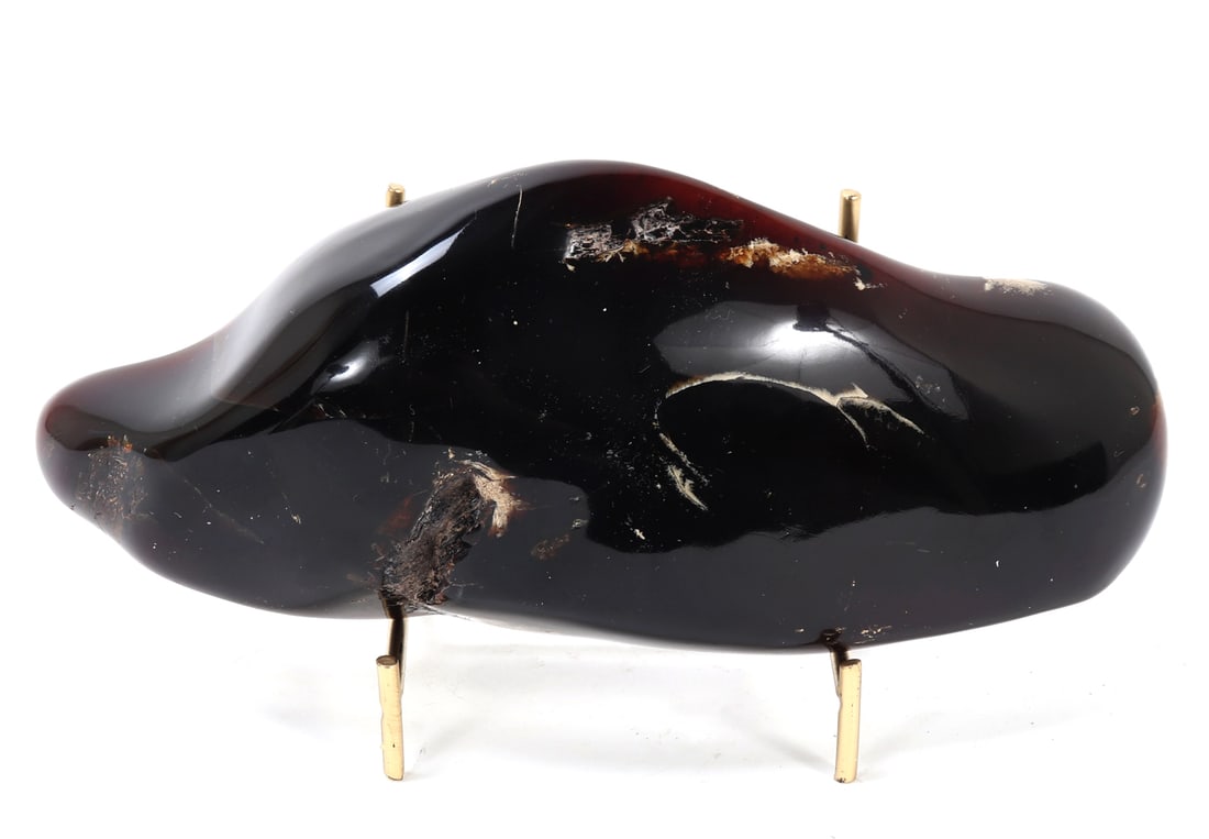 Wonderful Large Freeform Amber Section on/Stand: Beautiful large freeform section of ancient petrified amber with natural crystallizations throughout. Wonderful warm red and caramel coloring throughout with translucency when held to natural sunlight