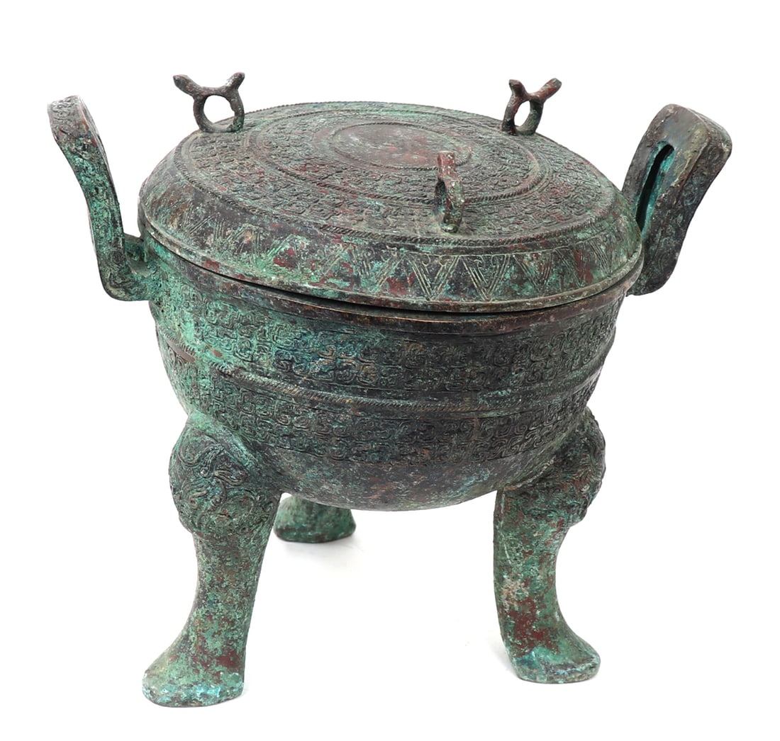 Bronze Ritual Tripod Food Vessel: Large Chinese bronze lidded archaistic style ritual food vessel with tripod legs. The lid covered in archaistic decoration with three loop handles to the top. The bowl decorated with numerous bands