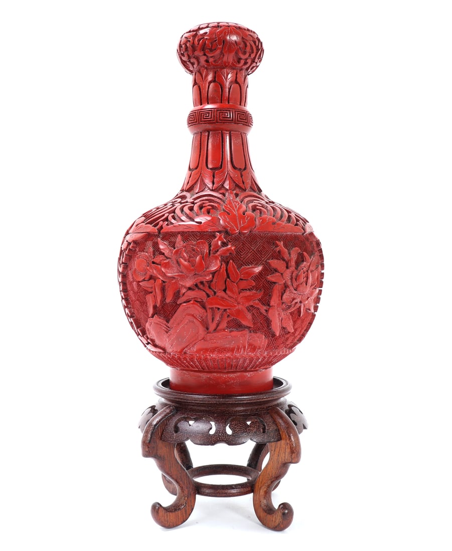 Beautiful Antique Chinese Cinnabar Vase w/Stand: Gorgeous intricately carved Chinese cinnabar vase. Vase is a copper based vase with carved applied cinnabar to the exterior. Beautiful floral background with leaf designs to the tall narrow neck and