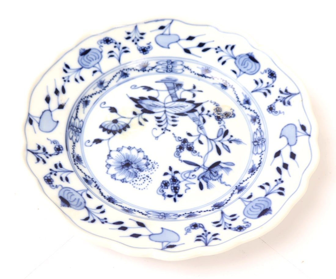 Meissen Blue & White Painted Porcelain Plate: Lovely blue and white painted Meissen porcelain plate depicting blooming flowers throughout with a lovely and uniquely shaped scallop rim, slightly concave center with lovely decorated edge. Size 7"