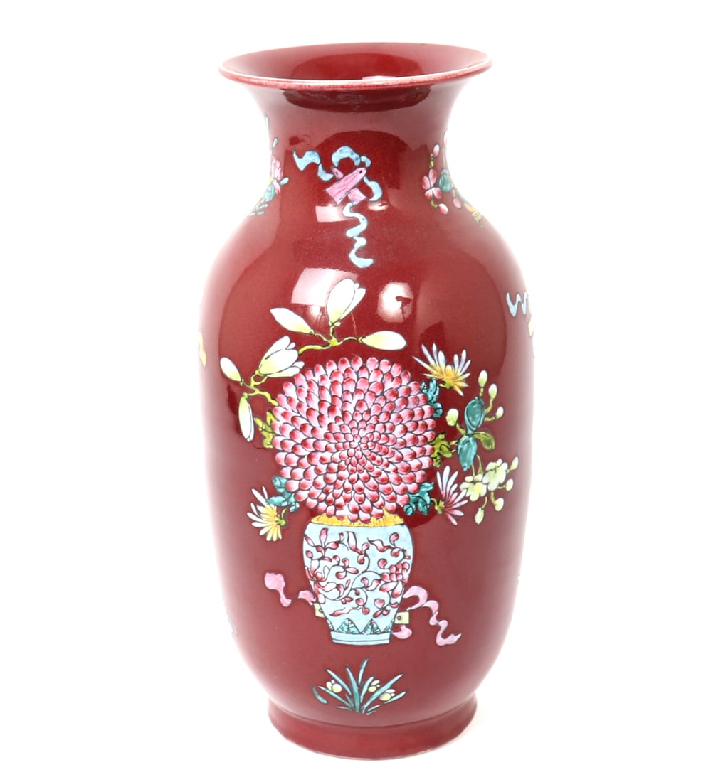 Chinese Decorative Red Glazed Flower Vase: Beautiful wine red glazed Chinese flower vase, with vases containing blooming flowers painted to each side. Lovely floral and ribbon detailing to the neck. Size 17" H