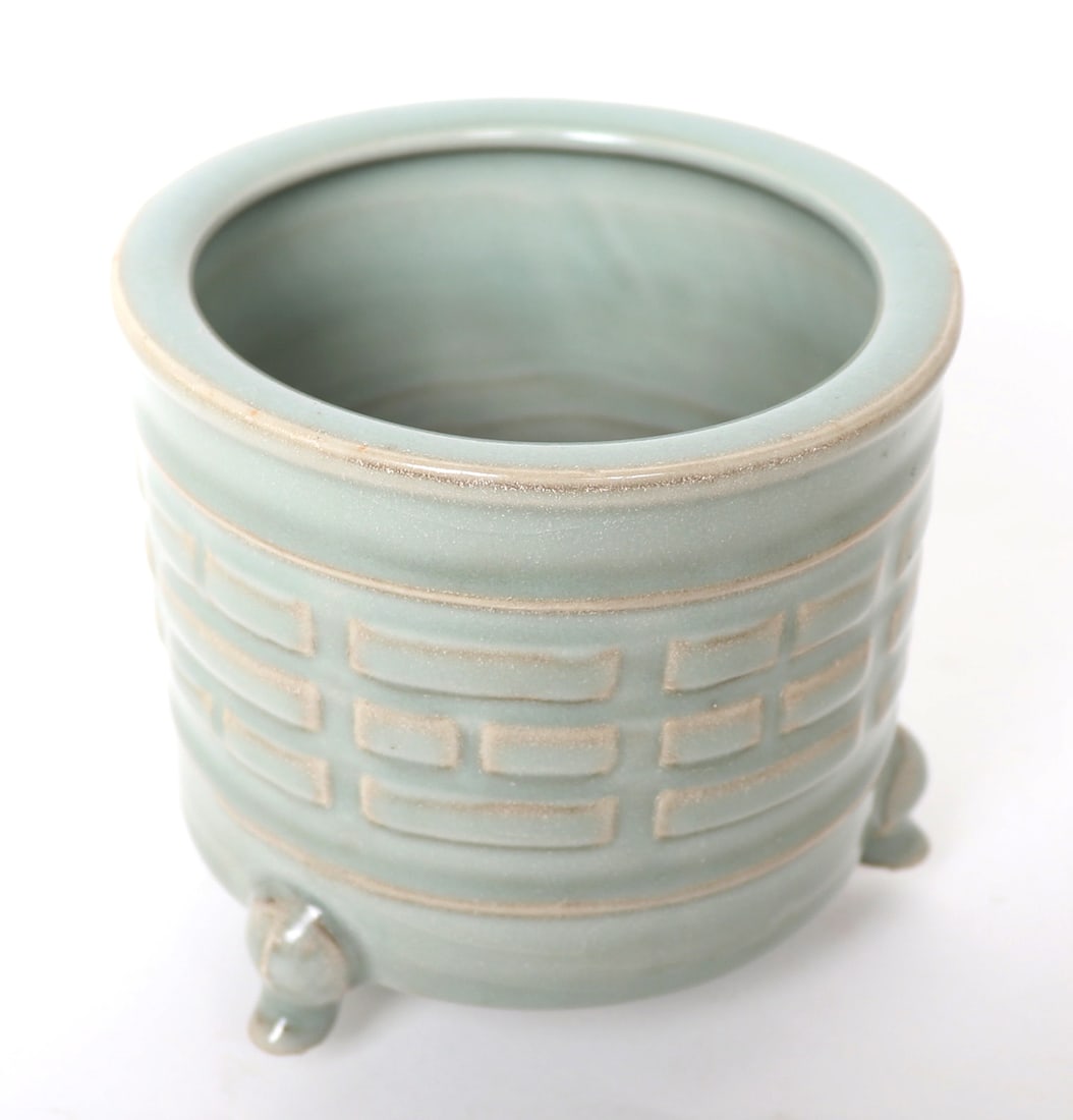 Chinese Celadon Tripod Vessel: Lovely Chinese tripod porcelain pot, green celadon glazed with brick banding throughout the mid-section. Inset rim and petite tripod 'feet'. The pot has a raised pedestal unglazed foot. Size 4 1/2" H