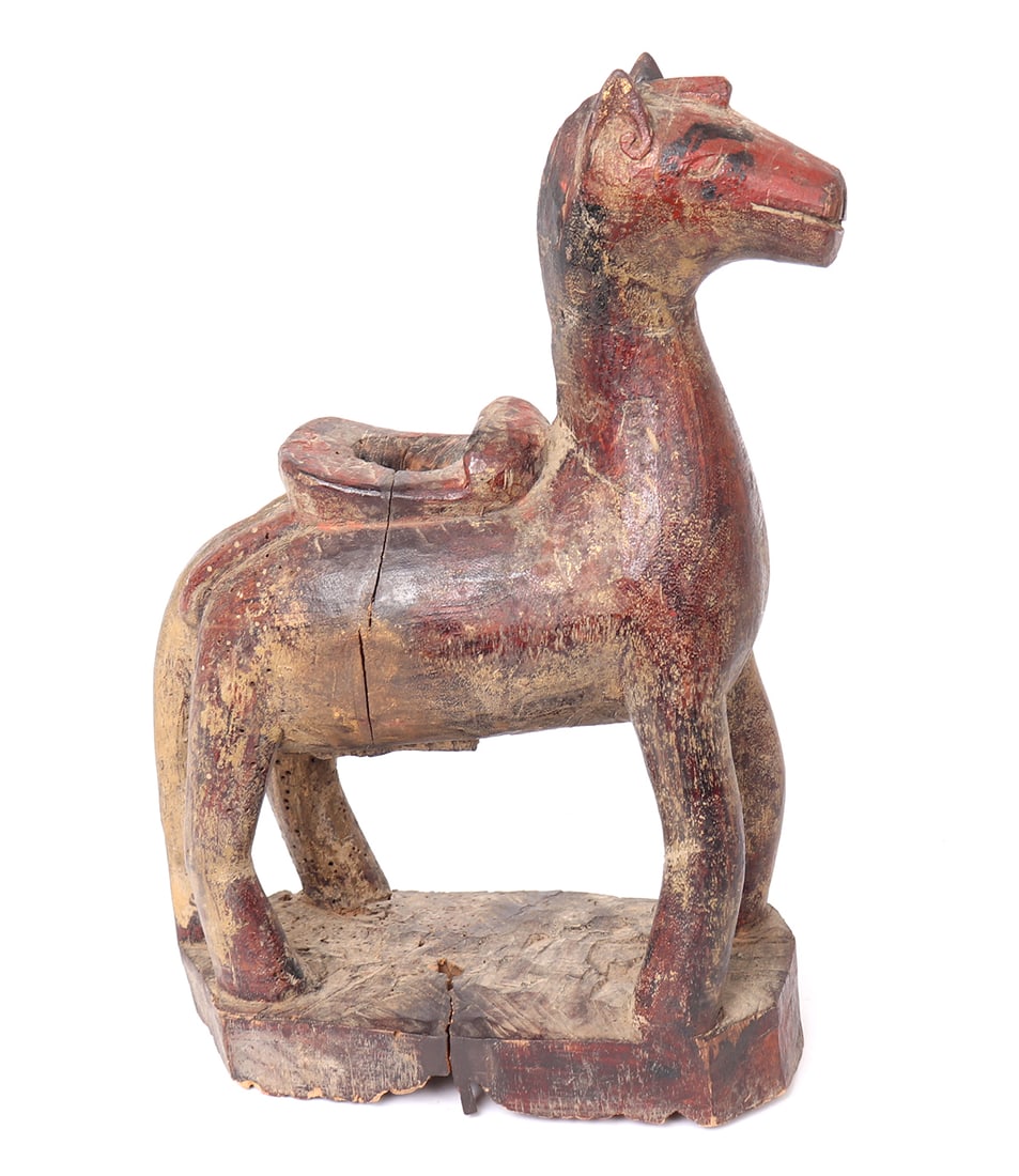 Indian Gilt & Painted Wood Horse Statue, circa 1800s: India, probably Rajasthan circa 1800s carved Indian painted wood horse statue. Painted in red with highlights in black paint and some remnants of gilding throughout. The horse with saddle pierced to t