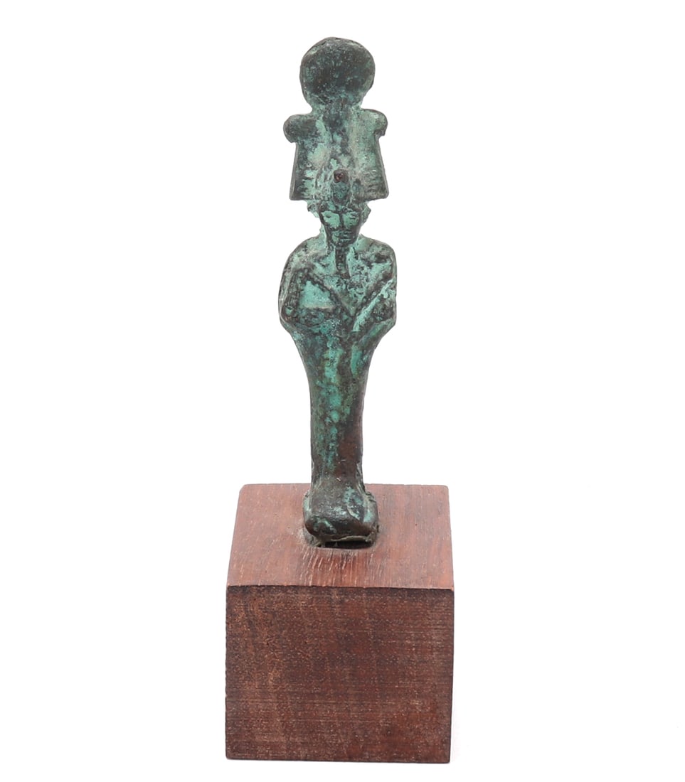 Ancient Egyptian Bronze Figure of Osiris: Early finely cast bronze figure depicting Osiris, the revered Egyptian god of the afterlife, fertility, and resurrection, rendered in his iconic mummiform stance. The deity stands, enveloped in a