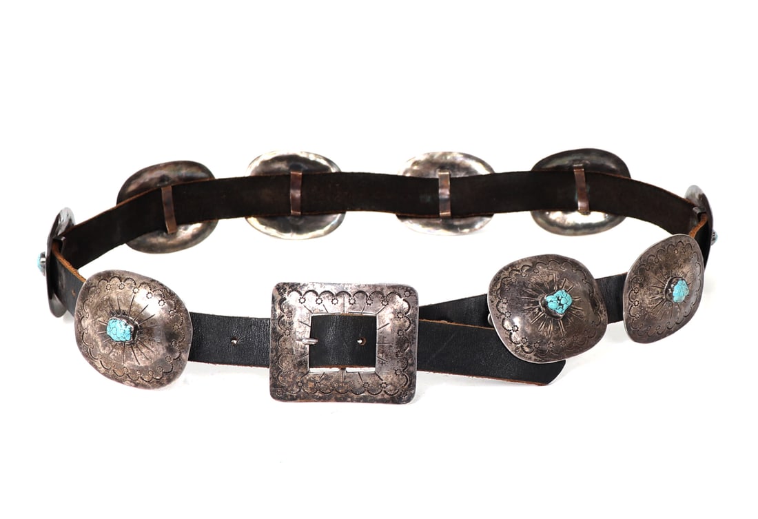 Rare 1950s Navajo Turquoise & Sterling Silver Concho Belt: Fine example of a Navajo Native American sterling silver concho belt, consisting of 9 oval stamp decorated conchos and rectangle buckle on a leather belt. Beautiful hand hammered detailing throughout