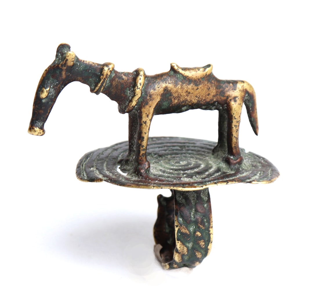 Dogon Gilt Bronze Ring of a Horse, 18th c.: Africa, Mali, Dogon culture 17th-18th c. Bronze ring of a gilt standing horse with saddle and ringed neck, the base of the ring is a circle of bands in bronze with significant gilding remaining. Size