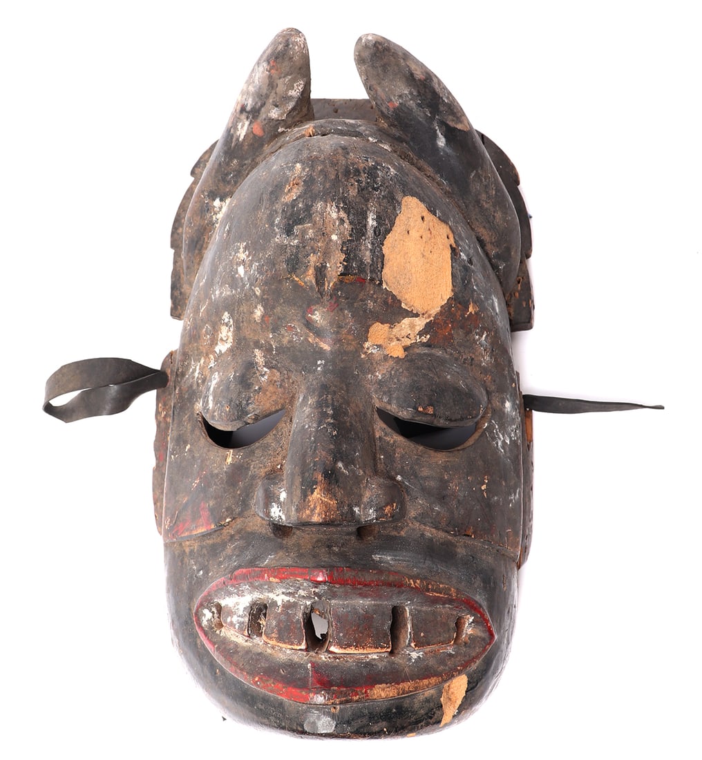 Exceptional Ibibio Eket Painted Wood Mask, 20th c.: West Africa, Nigeria, Ibibio Eket painted wood mask 20th century. Well carved and painted mask with horns, colored black beard, bright red lips and pierced openwork teeth. The eyes appear to be shut
