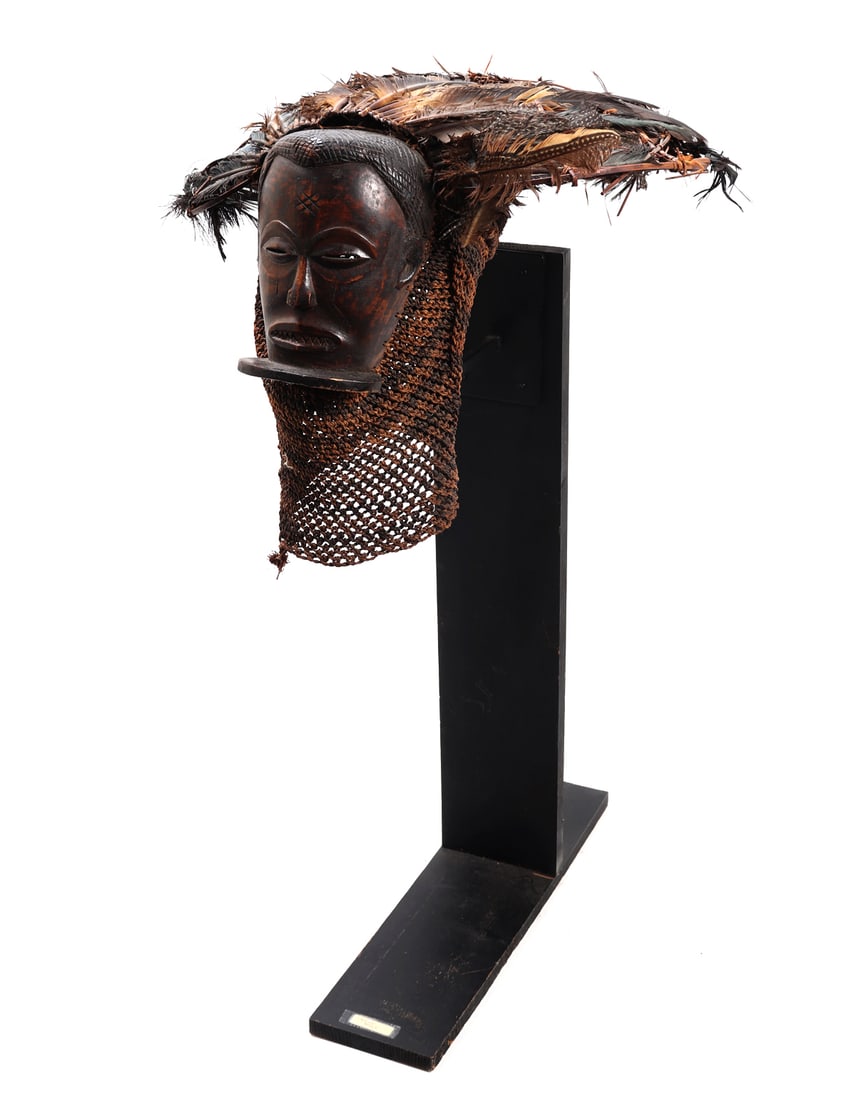 Chokwe Angola Wood Carved Ceremonial Mask: Chokwe Angola, wonderful wood carved helmet mask. Wooden face is accentuated by a skillful use of natural pigments, braided woven fiber under the chin, with a handsome feathered headdress. Such masks