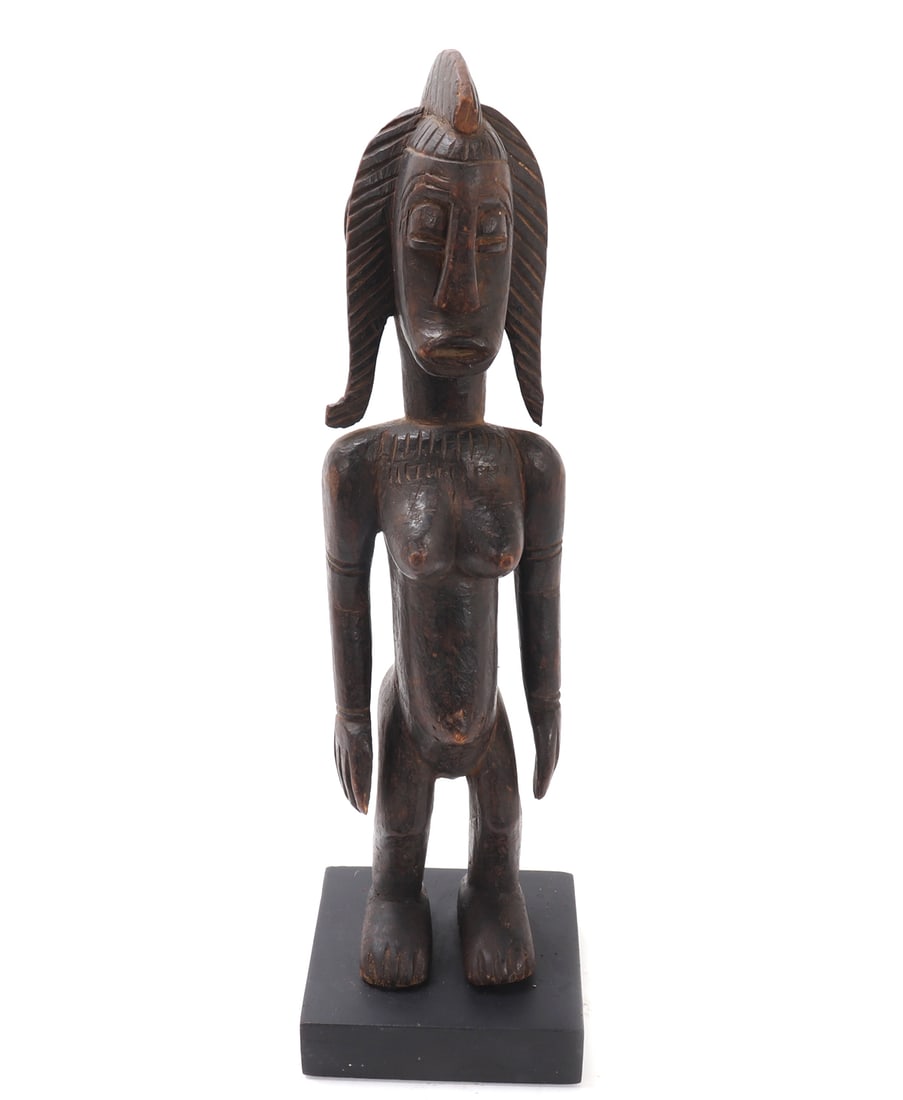Wood Carved Bamana Female Figure w/Stand: Nicely wood carved Bamana female figure with an elaborate coiffure. Depicted standing in the nude with arms at her sides. Plump breasts and rear end in classic form. Incised facial features with