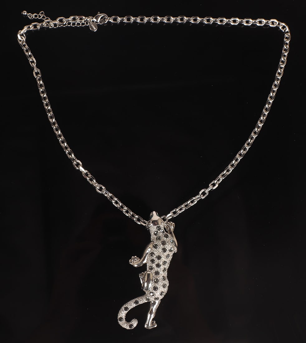Cartier Style Silver Leopard Pendant: Beautiful silver jaguar pendant with emerald colored eyes, and almost galaxy style diamonds to his back and tail. The leopard lays crawling up towards the lucky wearer. Suspended on a chain link