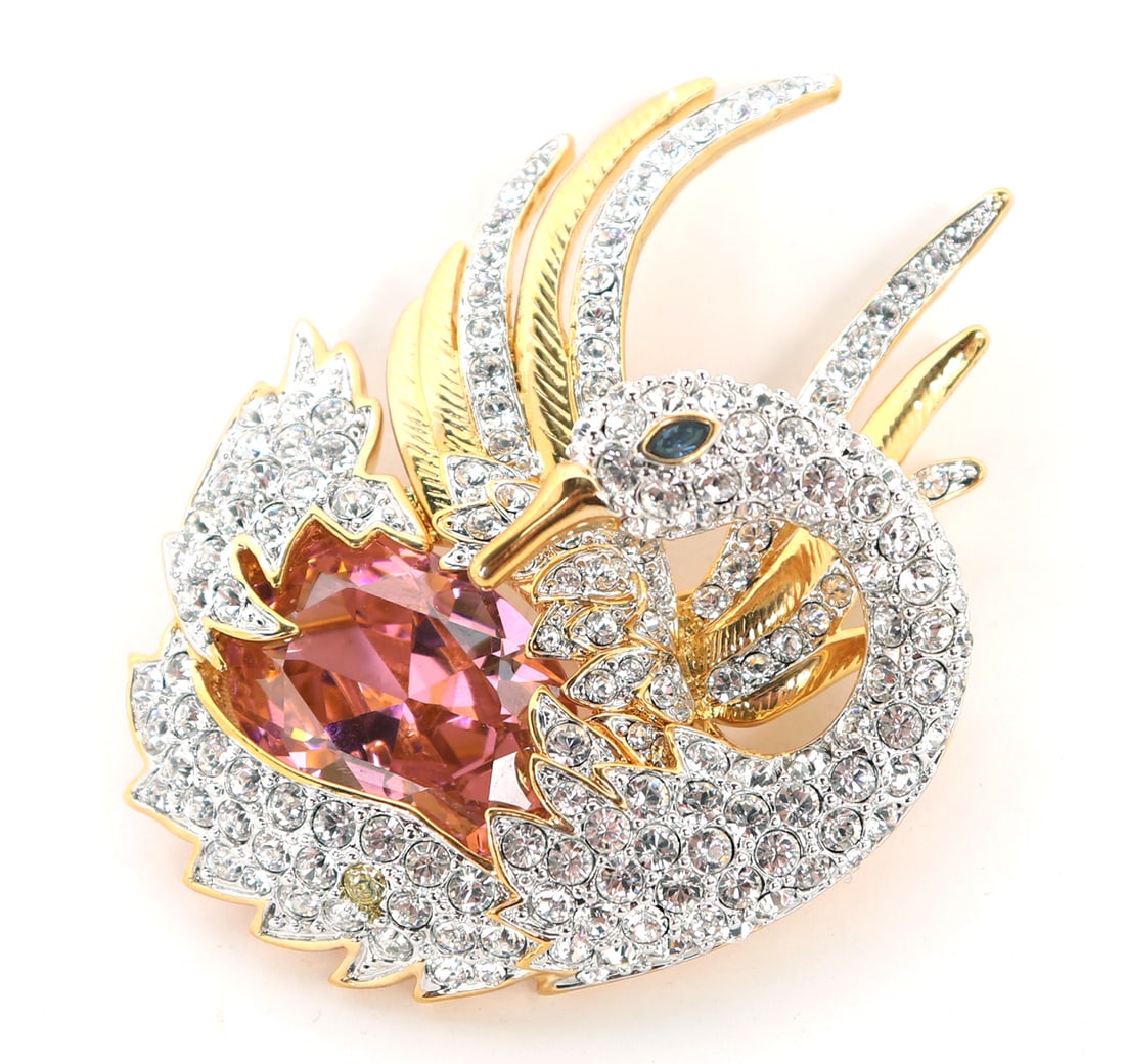 Lovely Nolan Miller Vintage Swan Brooch: Nolan Miller vintage swan brooch with lovely details throughout. Dazzling clear rhinestones, along with emerald colored rhinestones stones and a bright vibrant pink center rhinestone. Size 2 1/2" H