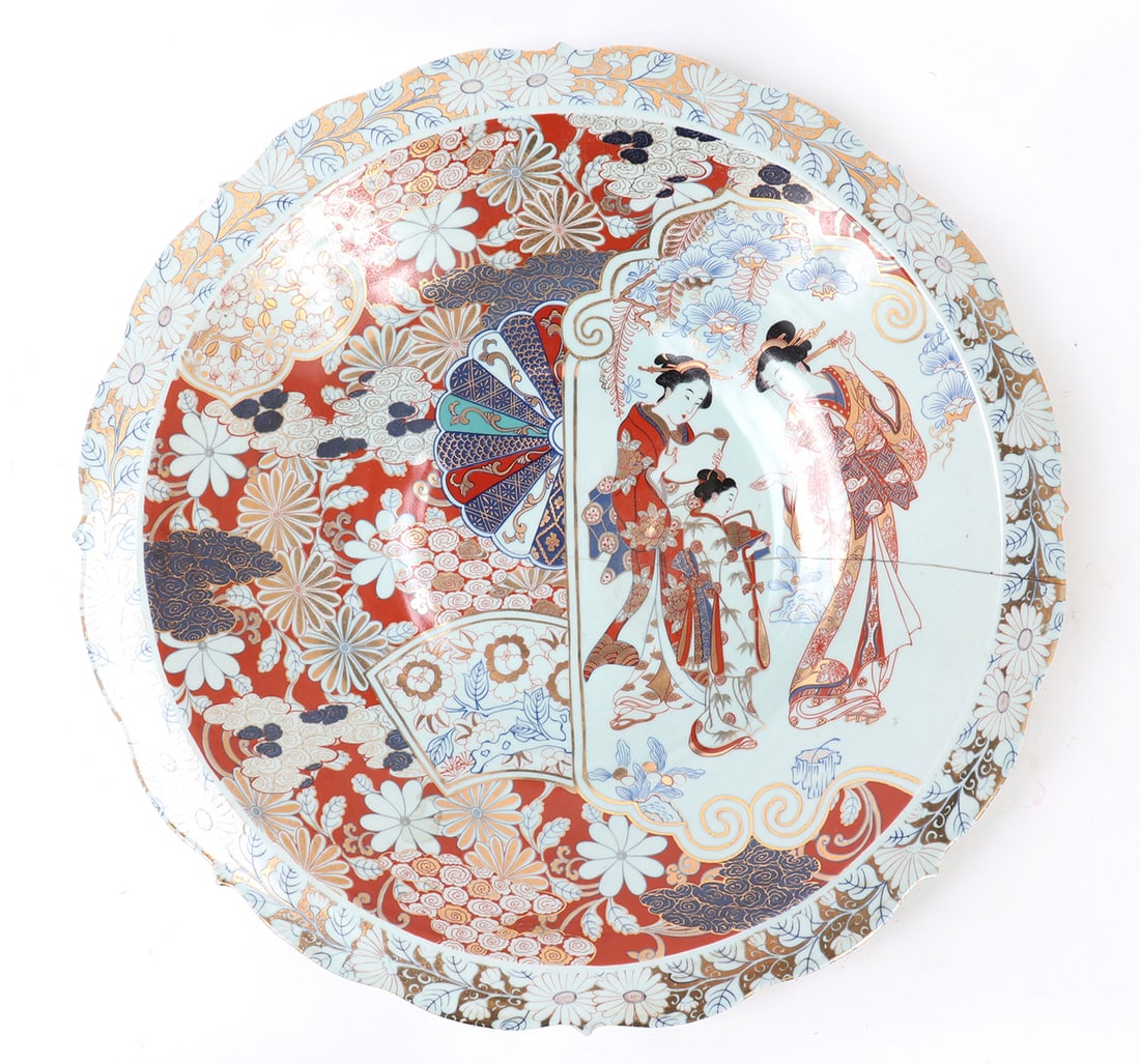 Japanese Porcelain Imari Charger: Beautiful large Japanese Imari painted charger with a flower petal rim, slightly raised base. Geisha girls appear to be preparing for a next show or performance. Painted throughout with gold, red and