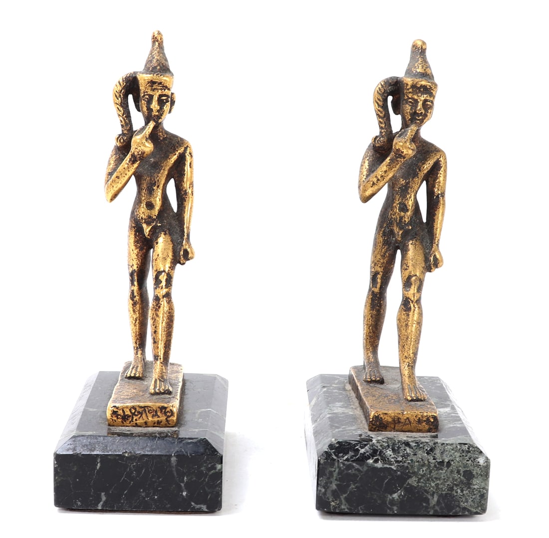 Fine Pair of Brass Harpocrates Bookends on Marble: Lovely pair of brass cast statues of Harpocrates on lovely Italian marble bases. Classically depicted in the nude with a double crown, his right hand raised to his lips as a form of silence and