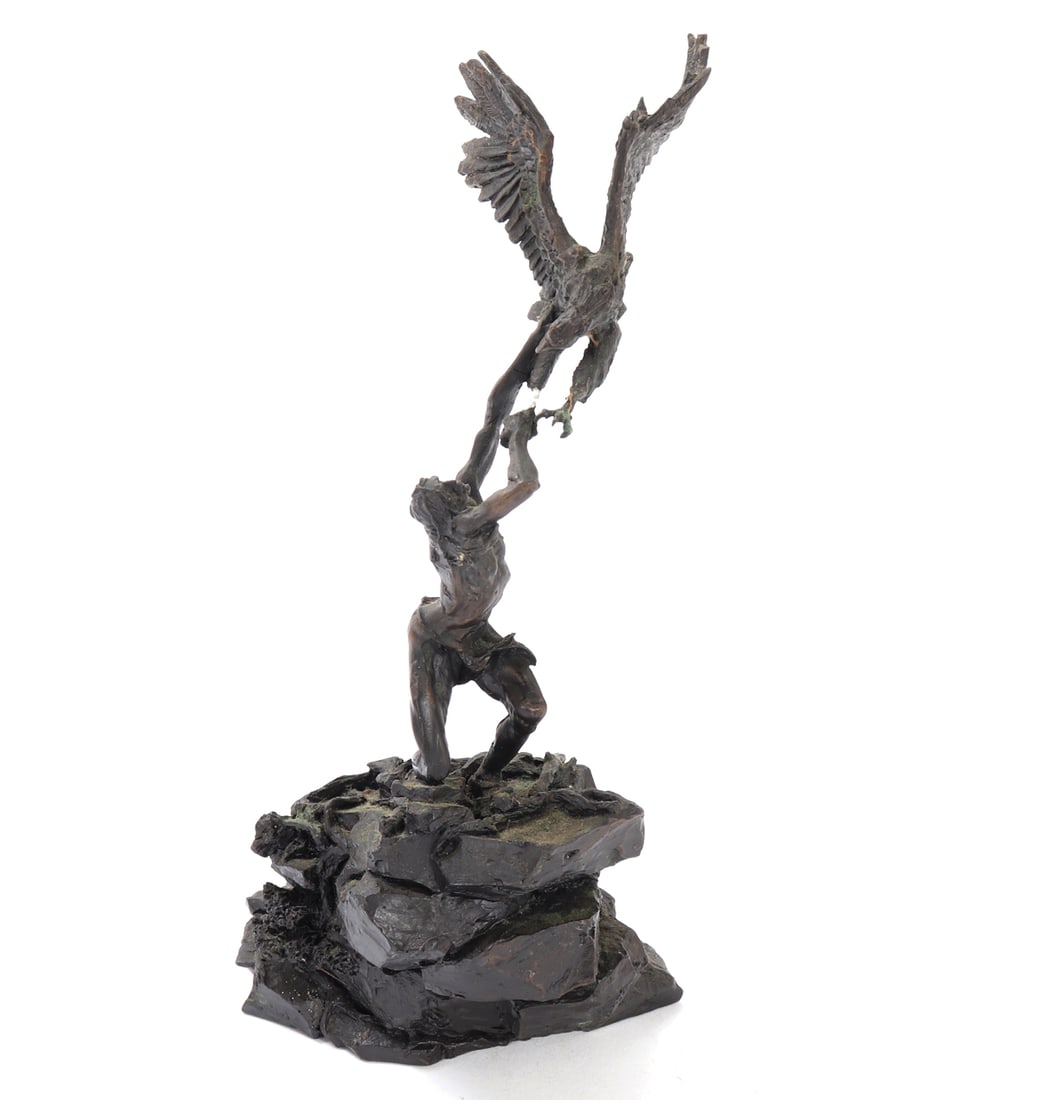 The Eagle Catcher by Michael Boyett, 1982: Handsome statue depicting a Native American man reaching up to catch a large eagle as it tries to flee from his grasp. Signed to the base by the artist and dated 1982. Size 9 3/4" H, Weight 1 lb.