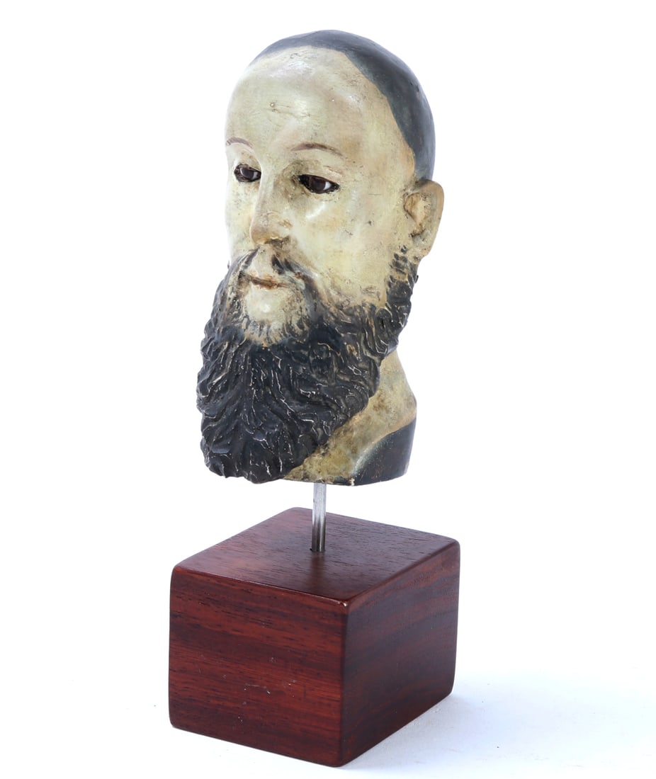 Late 19th to Early 20th Century, Wood Carved Santo Head: Handsome wood carved Santo with original glass eyes. Painted throughout with a white pigment to the face, ears and neck, brown hair and long beard. Mounted on a custom wood stand for proper display.