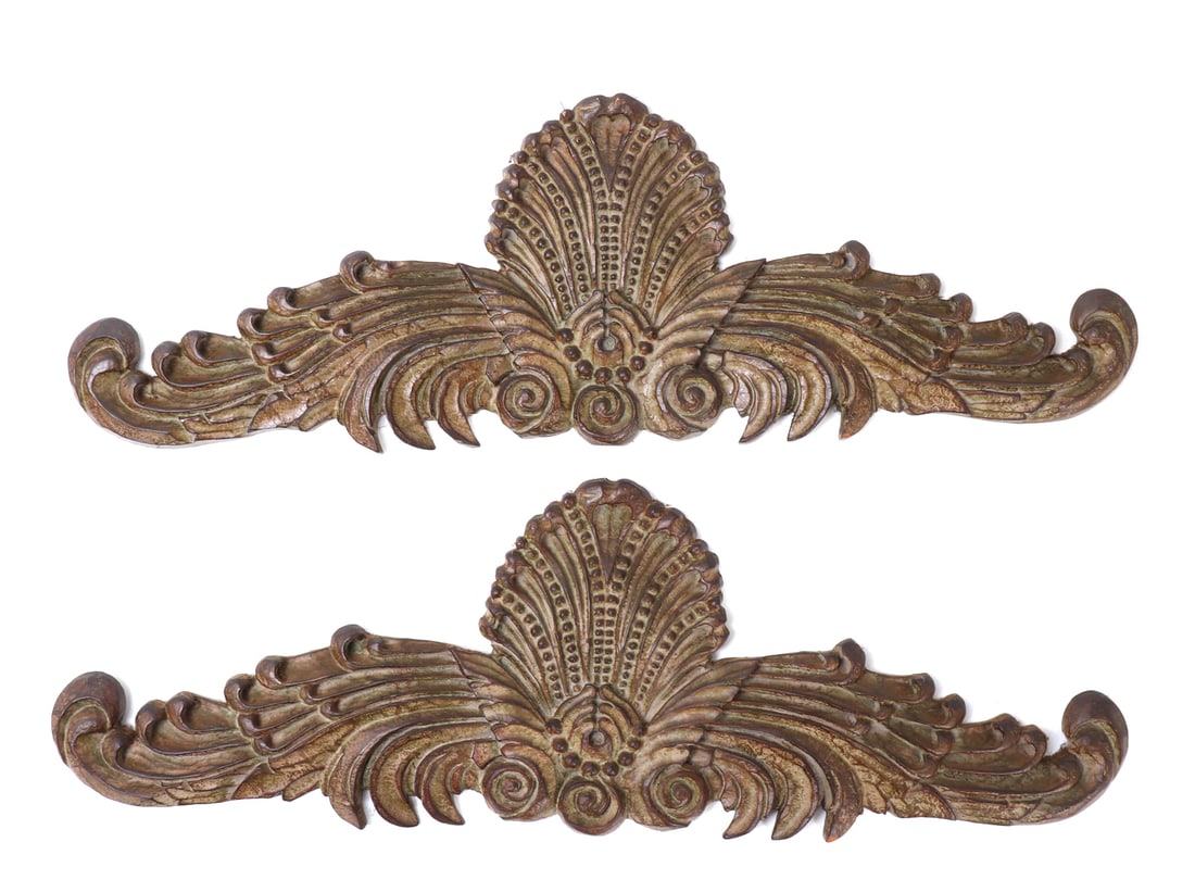 1980s French Style Wooden Accent Wall Ornaments: Lovely pair of French hand carved wooden accent wall ornaments, each featuring a central beaded shell motif with long scrolling arms out to each. Faded gold gilt paint with a fine green aged patina