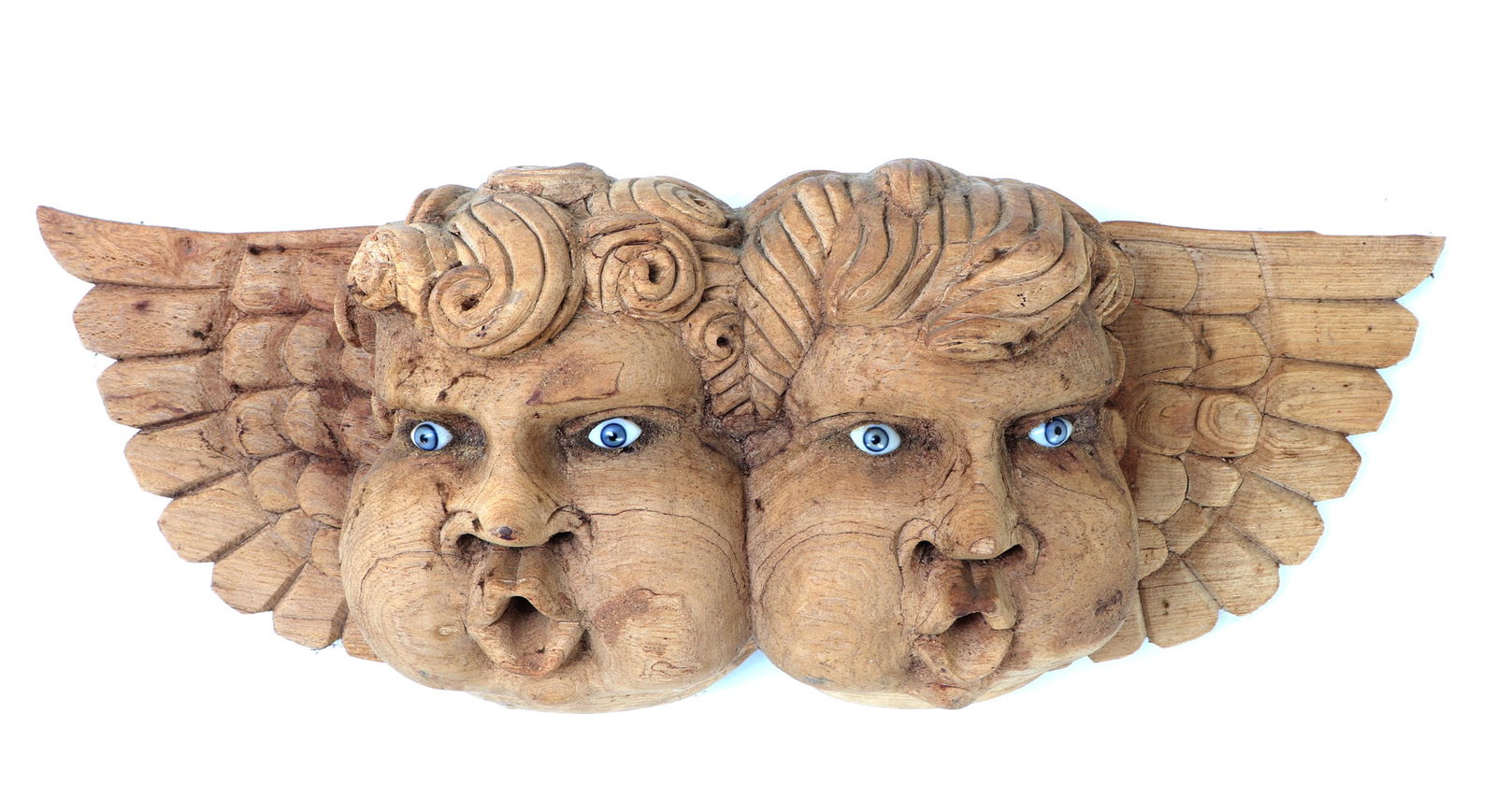 Fine Spanish Colonial Style Wood Angel Carving: Spanish Colonial style wood carved wall decor, featuring a pair of winged cherubic faces. Bright blue glass style eyes with chubby cheeks and curled hair. Size 24 3/8" W, Weight 3 lb. 9.2 oz
