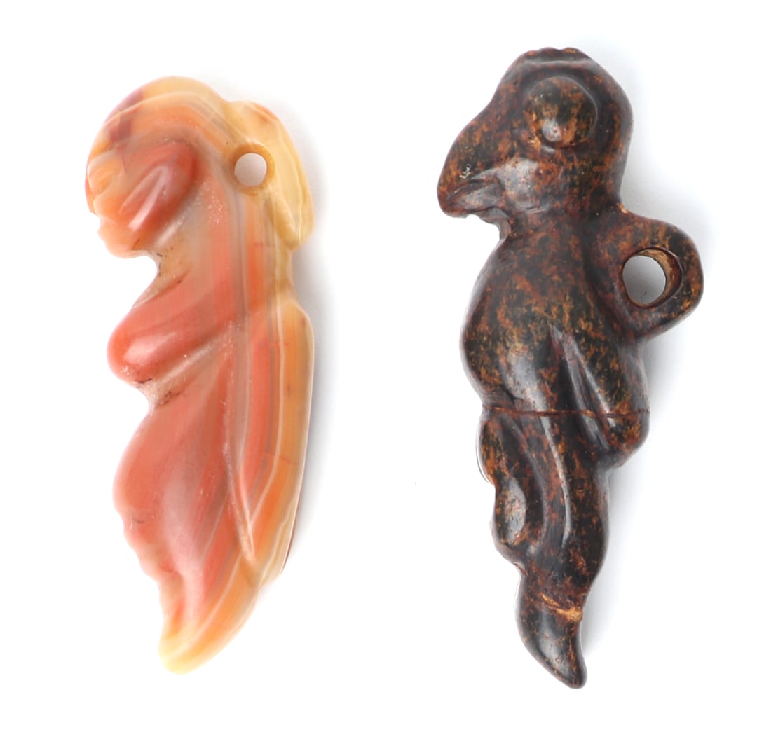 Two Chinese Stone Zoomorphic Stone Pendants: Amber light colored stone figure and a dark brown with marbled black figure, each carved with a suspension loop for stringing as a pendant. Size larger 2 1/2" H