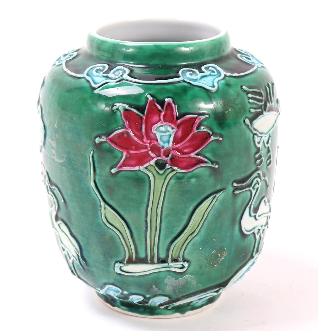 Lovely Chinese Green Glazed Porcelain Ginger Jar: Beautiful Chinese green glazed porcelain ginger jar, decorated in high relief throughout. Ruyi scepter designs around the shoulder with lily pads and flowers in high relief through the entire body.