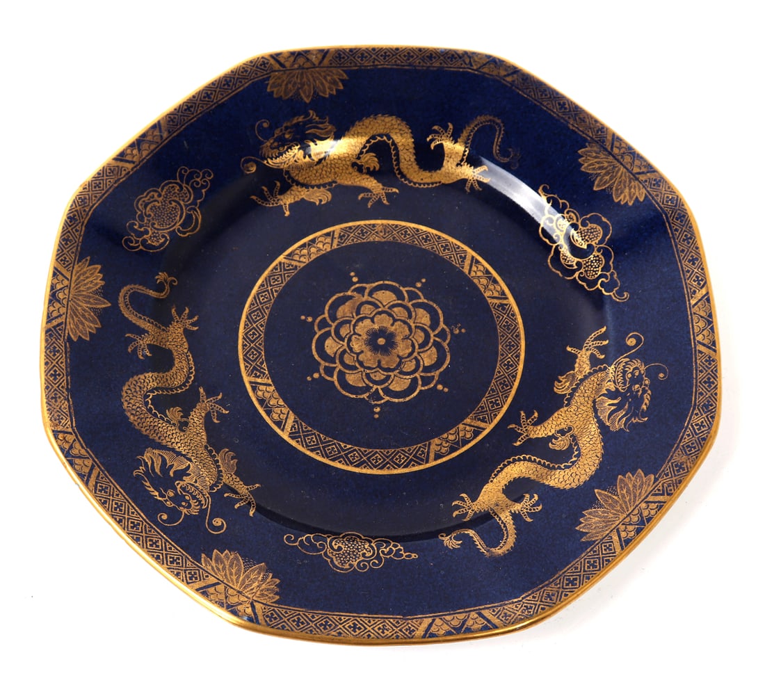 T. Goode & Company Blue & Gold Dragon Plate: Lovely porcelain plate painted all over in a deep blue with gold accents in dragons and geometric details throughout. Marked to the base T. Goode & Co Ltd, London W 3.98. Size 9" L x 9" W x 1" H,