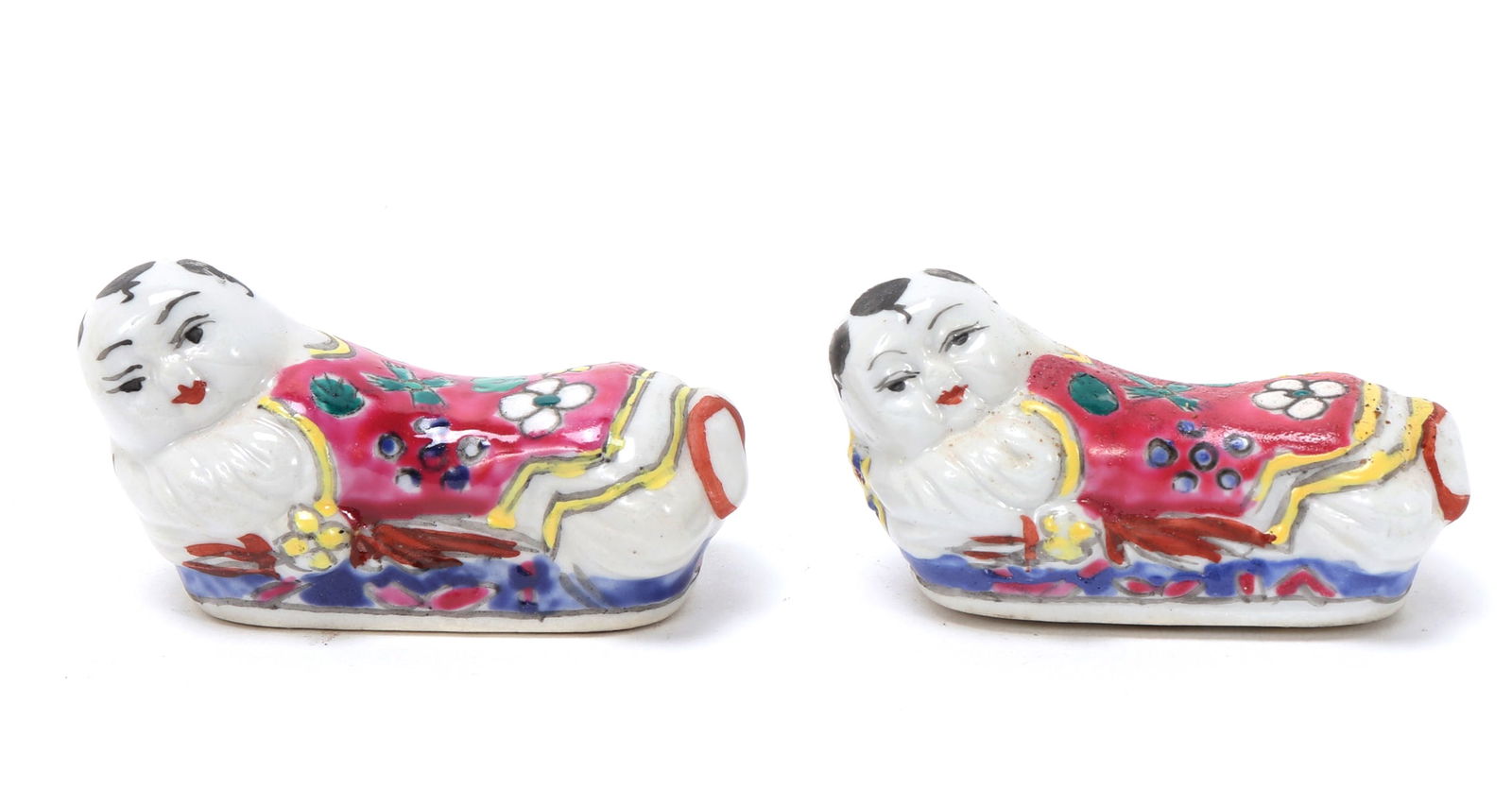 Pair of Chinese Porcelain Brush Rests: Pair of Chinese porcelain scholarly brush rests, baby monks depicted on their bellies with bright pink floral robes. Size 2 3/8" L