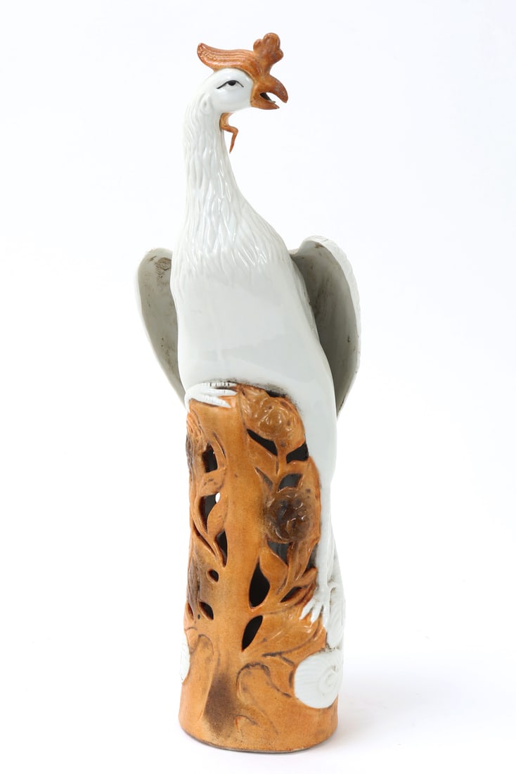 Chinese Porcelain Pheonix Statue: Chinese white glazed porcelain phoenix statue, depicted on an open wood colored base with flowers in high relief throughout. Four character mark to the base. Size 17 3/4" H