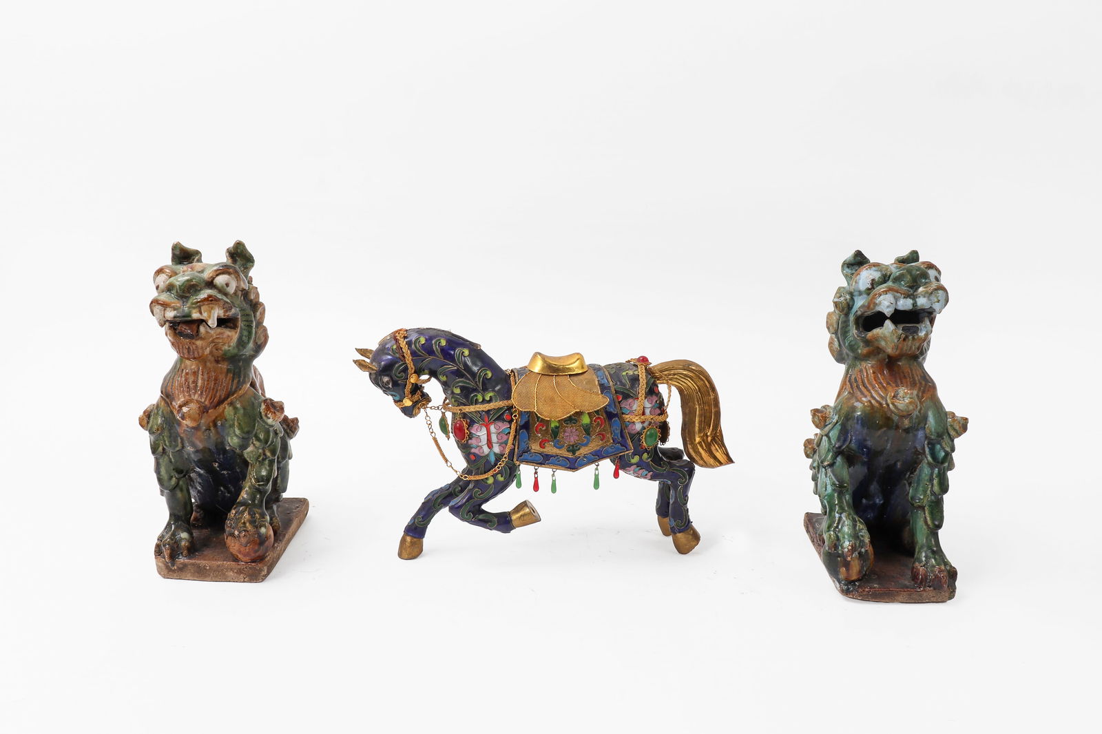 Chinese Ceramics & Cloisonne Group: Pair of guardian lion statues in ceramics and one Cloisonne enamel decorated horse with excellent gilt metal features. 3pcs 10" tallest 11" widest