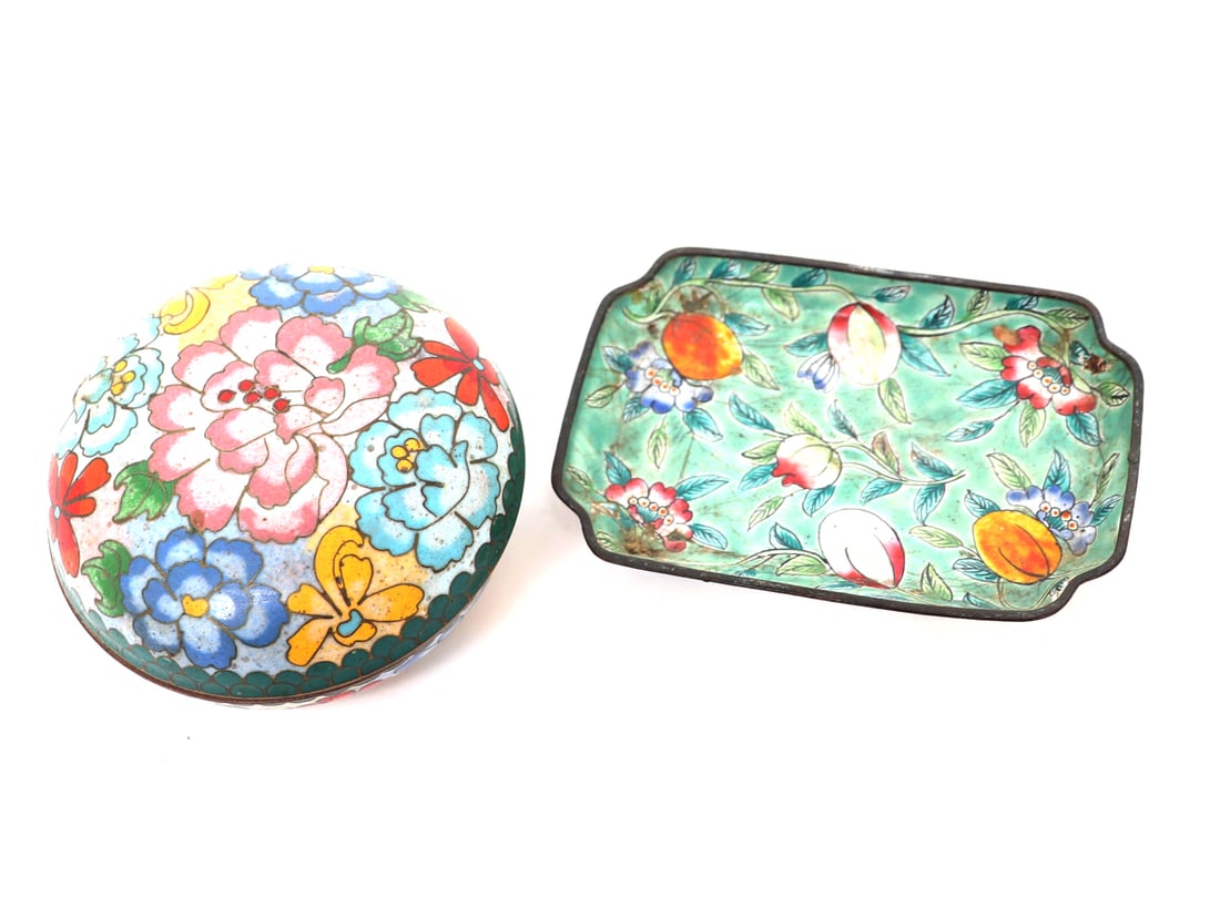 Chinese Cloisonne Enamel Smalls: Two attractive Chinese cloisonne enamel pieces. Including one tray with peach blossoms and fruit. Left a lidded stamp paste container in round form with lotus flowers in various colors. Size tray 3